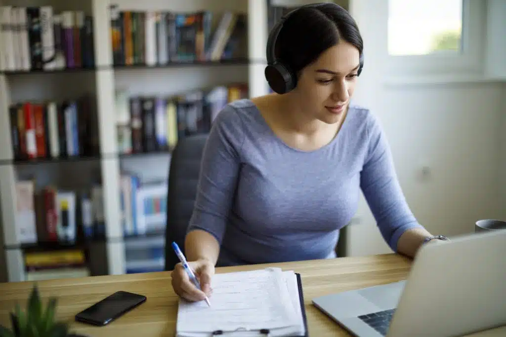 Young woman with headphones working from home