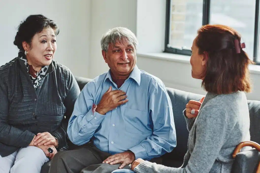 Female carer treating senior couple