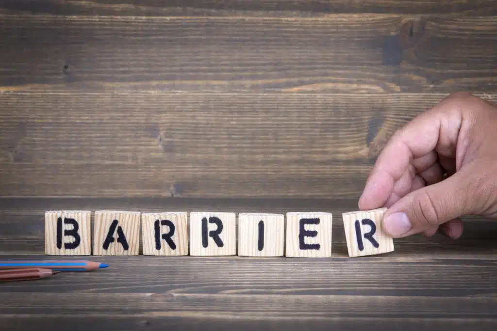 Barrier. Wooden letters on the office desk, informative and communication background