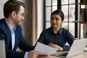Professionals discussing documents in an office setting, representing certified translation services Canada.