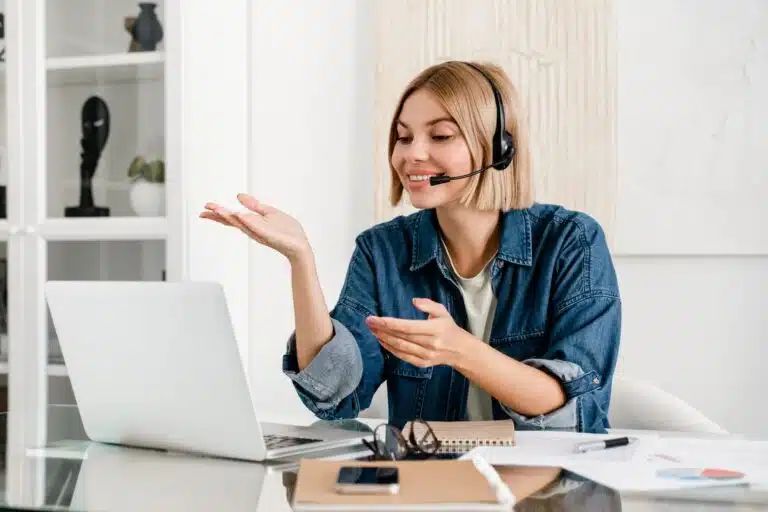 Certified translator woman using a computer and headset to deliver accurate and trusted document translation services in Canada.